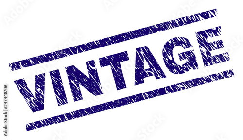 VINTAGE seal print with distress style. Blue vector rubber print of VINTAGE text with unclean texture. Text tag is placed between parallel lines.
