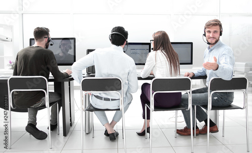 rear view.the operators of the business center sitting at a Desk