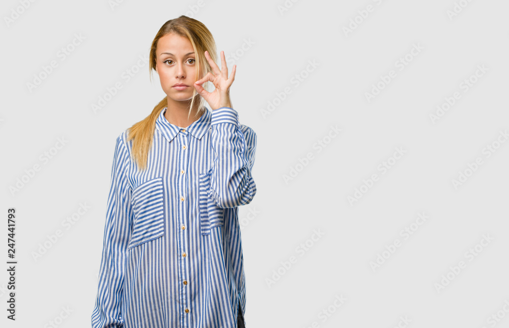 Portrait of a young pretty blonde woman keeping a secret or asking for silence, serious face, obedience concept Portrait of a young pretty blonde woman keeping a secret or asking for silence, serious face, obedience concept