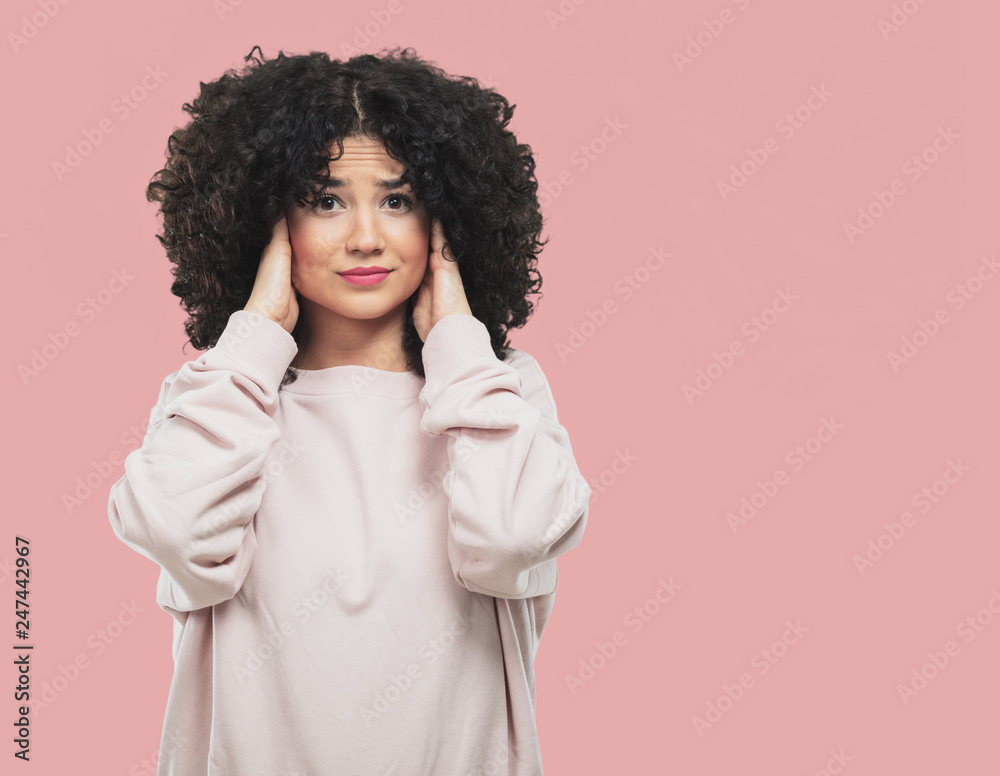 young woman covering her ears young woman covering her ears
