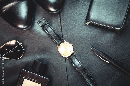 Men's accessories on leather background.