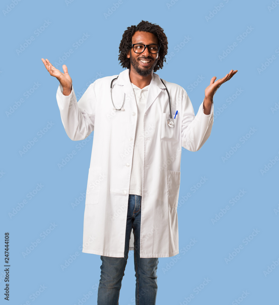 Handsome african american medical doctor laughing and having fun, being relaxed and cheerful, feels confident and successful Handsome african american medical doctor laughing and having fun, being relaxed and cheerful, feels confident and successful