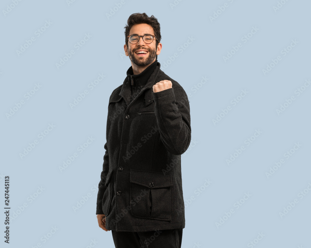 young man doing gesture of success young man doing gesture of success
