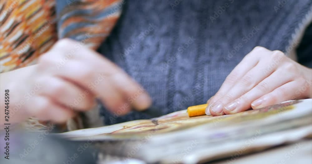 Young Hands of the Artist,Woman Artist Paints a Canvas with Graphite Pencils,Sitting a Ttable and Draw on Canvas. Process of Drawing: in Artist's Art Studio Hand Girl Sketching on Canvas.Shot Close-up Young Hands of the Artist,Woman Artist Paints a Canvas with Graphite Pencils,Sitting a Ttable and Draw on Canvas. Process of Drawing: in Artist's Art Studio Hand Girl Sketching on Canvas.Shot Close-up