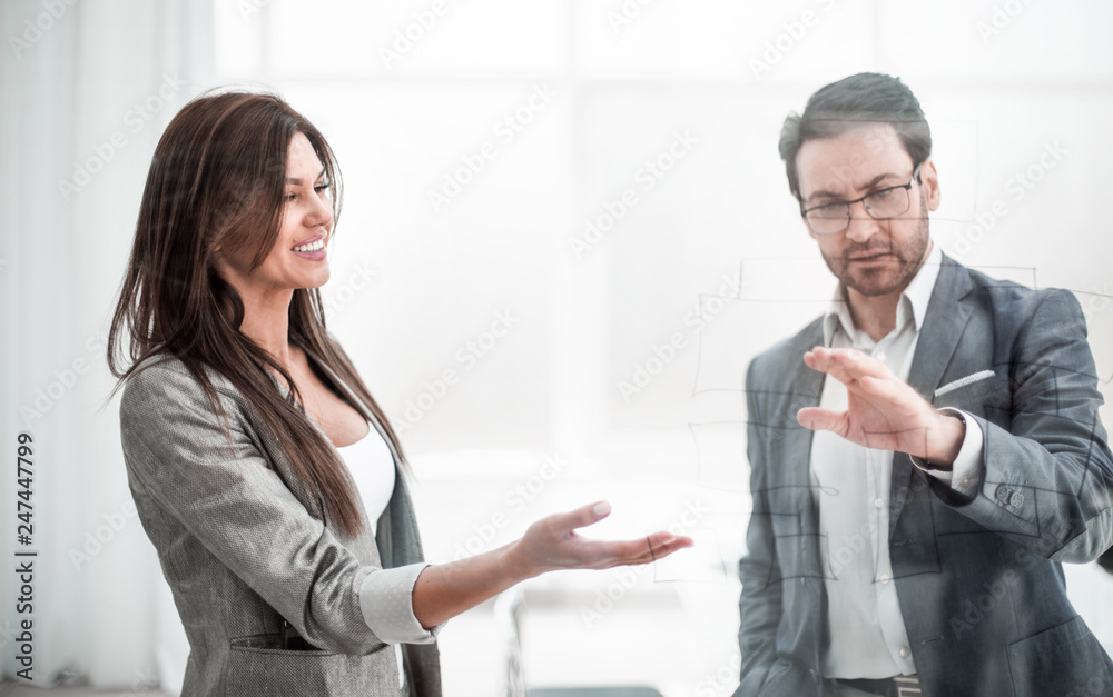 businessman and business woman discussing ideas for a new contract businessman and business woman discussing ideas for a new contract
