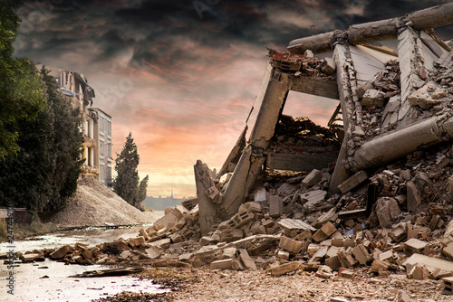 View on a collapsed concrete industrial building with dark red dramatic sky above Fototapeta