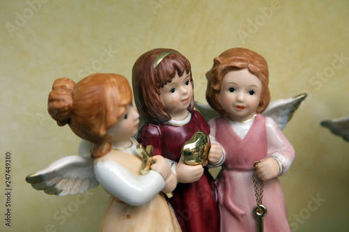 Three porcelain angels in a shop-window.