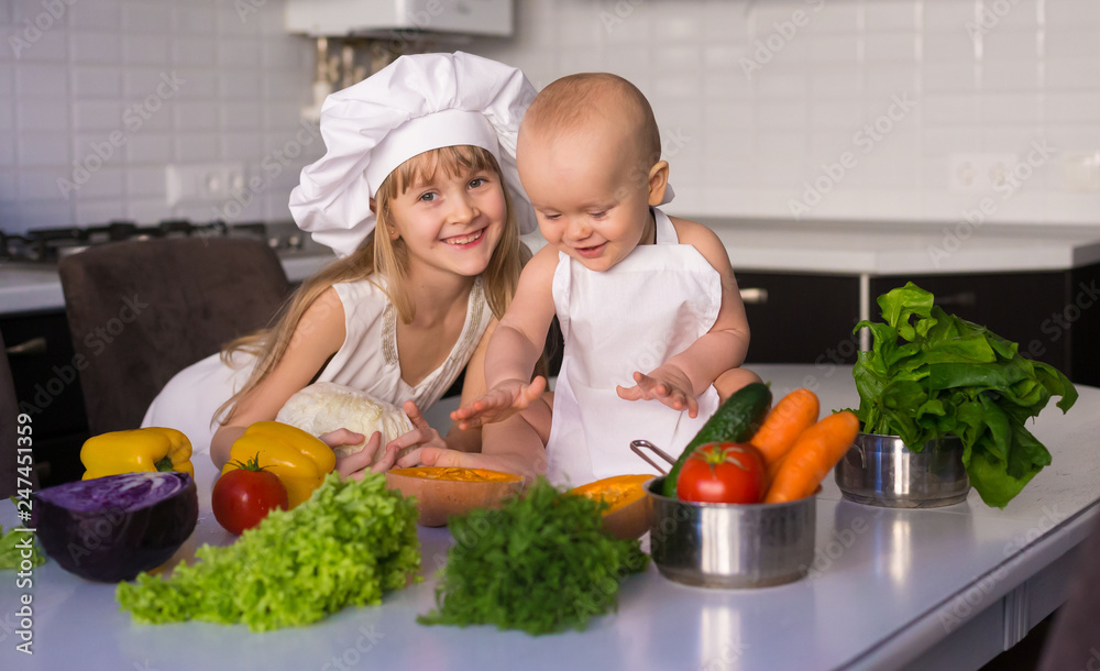 little girl and boy, white chef hat, vegetables little girl and boy, white chef hat, vegetables