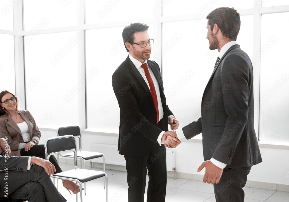 businessmen handshaking after striking grand deal businessmen handshaking after striking grand deal