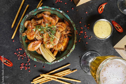 Beer mug, grilled shrimps, sausages and pretzel on wooden table. Top view