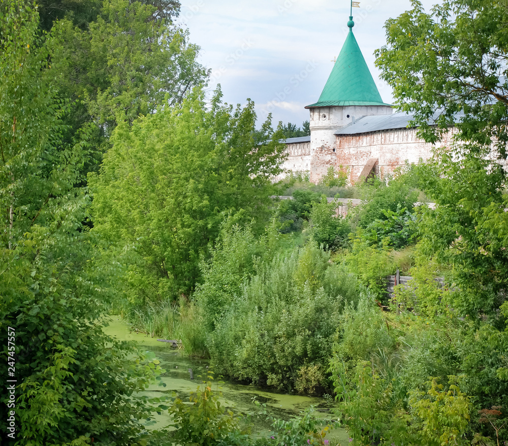 Ipativsky monastery - beautiful old architecture of russian orthodoxy church. Russia, town Kostroma. Summer, green trees Ipativsky monastery - beautiful old architecture of russian orthodoxy church. Russia, town Kostroma. Summer, green trees