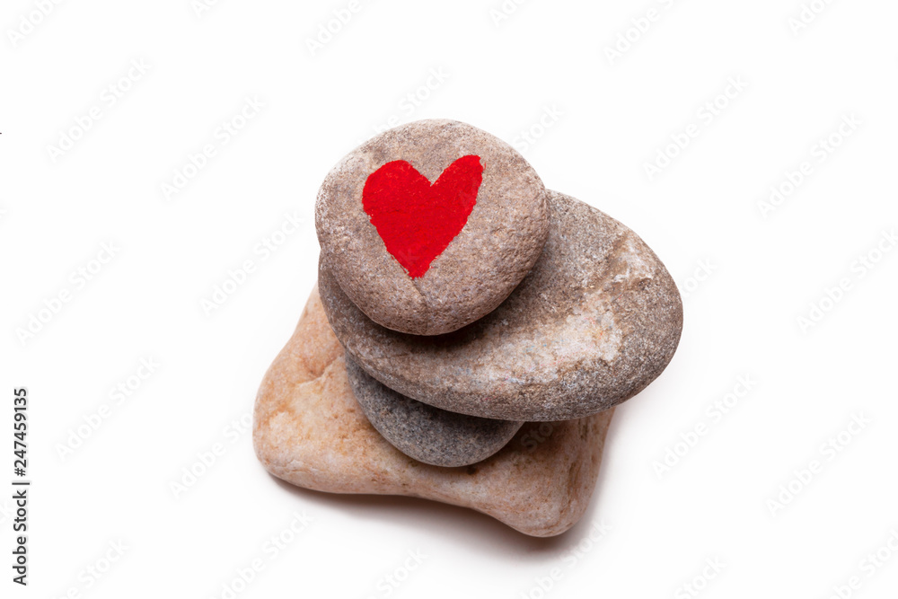 Obraz premium A pile of pebbles with a heart shape painted on the top one