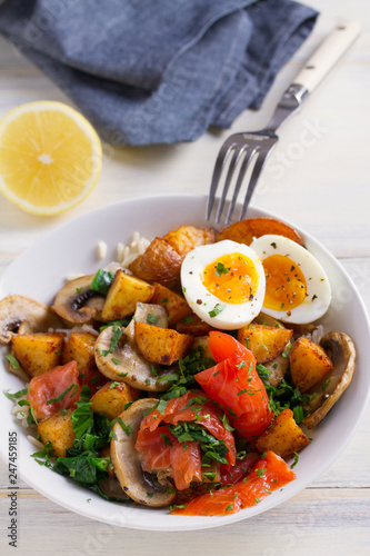 Healthy food bowl: salmon, eggs, potatoes, mushrooms, rice and spinach on white wooden table. vertical