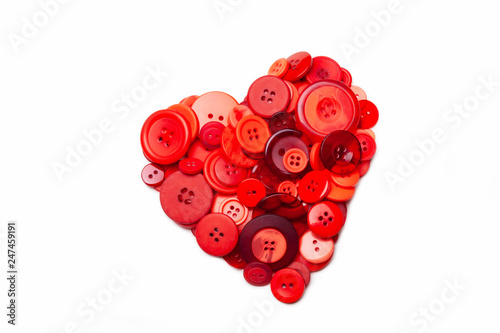 Heart made of red buttons isolated on white