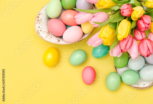 Pink tulip flowers Easter eggs decoration yellow background