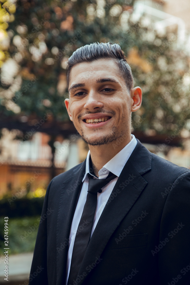 Face of smiling man with suit walking in park in Barcelona Face of smiling man with suit walking in park in Barcelona