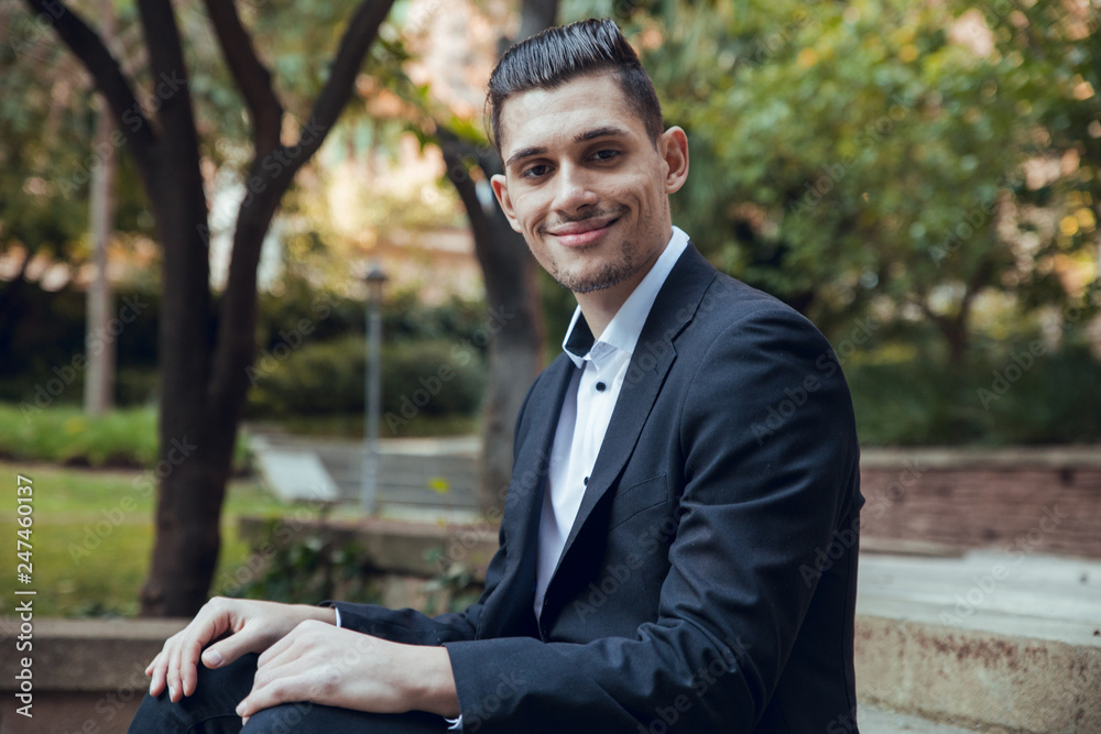 Close up Businessman of smiling sitting on park stairs Close up Businessman of smiling sitting on park stairs