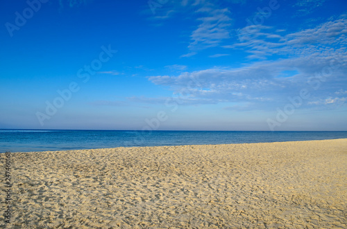 Clean  sandy beach against the blue sea.