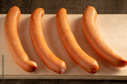 raw sausages on a light board, close-up photo