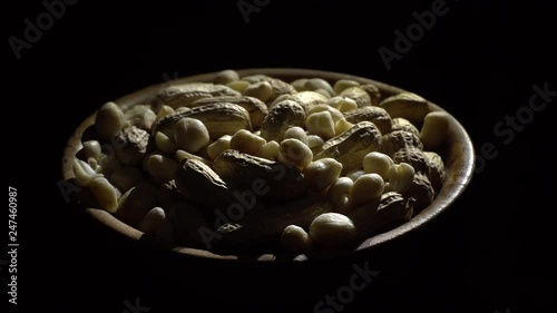 Peanuts. Mixed Peanuts in rotation. Snack closeup.  Peanuts in a bowl. Selective focus. black background. Studio shot. Healthy food concept.