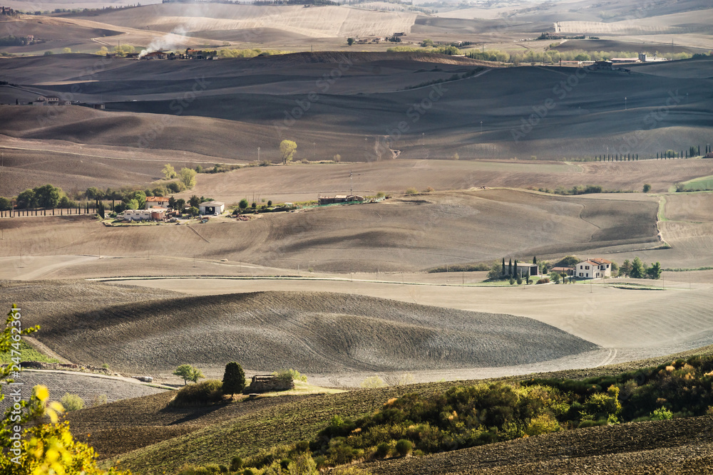 Autumn in Italy. Yellow plowed hills of Tuscany with interesting shadows and lines