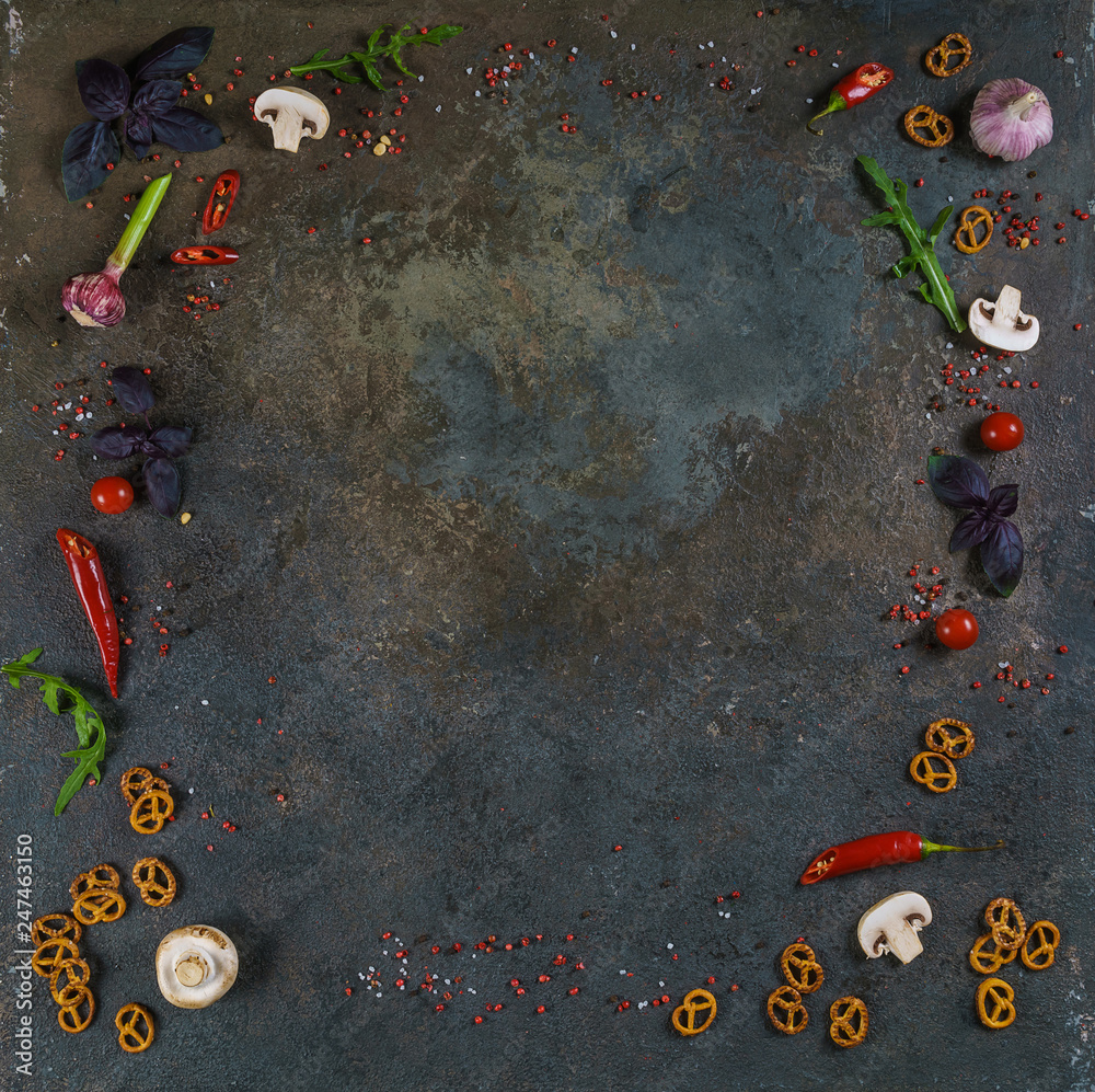 Selection of spices herbs and greens. Ingredients for cooking. Food background on black slate table. Top view copy space.