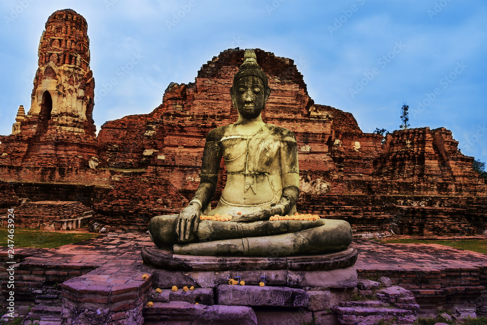 Ancient statue of sitting Buddha in Wat Mahathat temple. Ayutthaya historical park, Thailand. Artistic photo, toned. Ancient statue of sitting Buddha in Wat Mahathat temple. Ayutthaya historical park, Thailand. Artistic photo, toned.