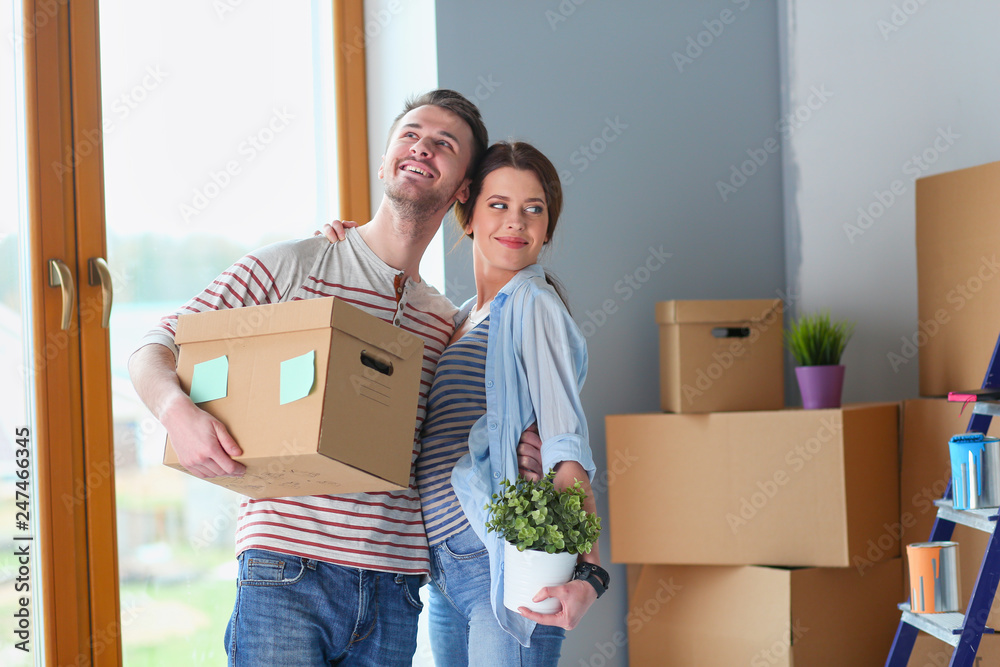 Happy young couple unpacking or packing boxes and moving into a new home. Happy young couple unpacking or packing boxes and moving into a new home.