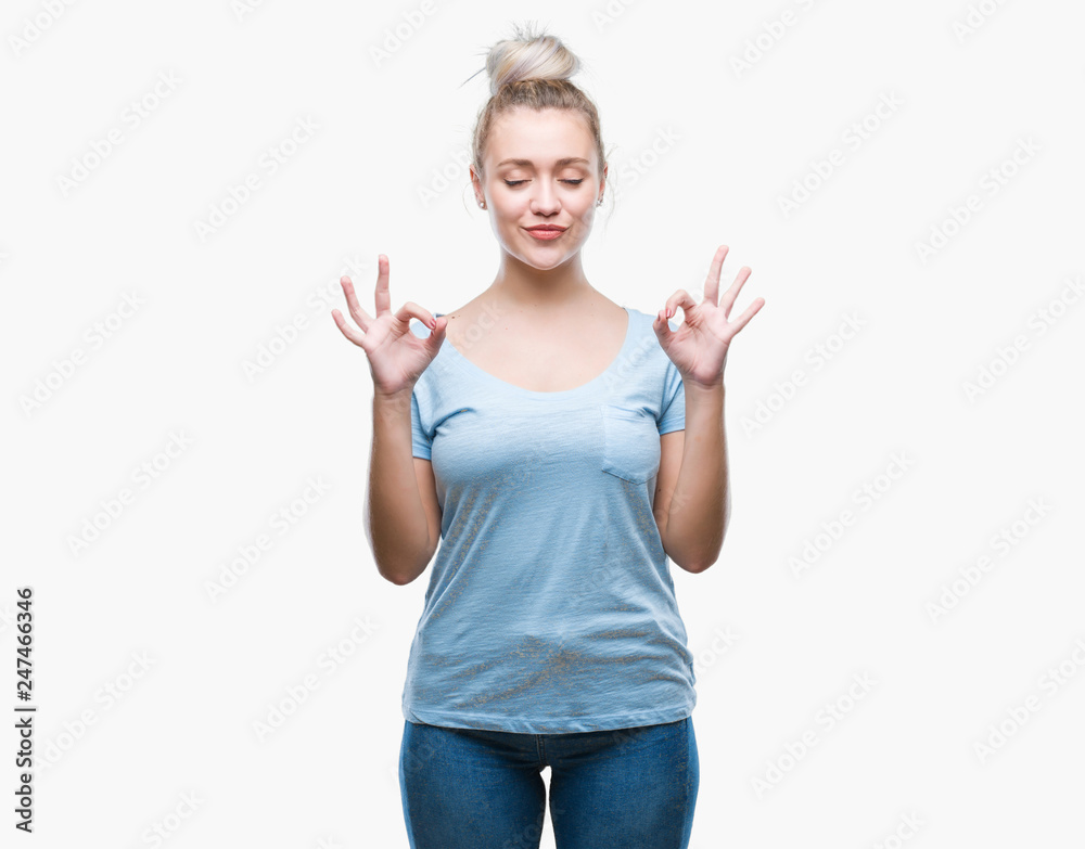 Young blonde woman over isolated background relax and smiling with eyes closed doing meditation gesture with fingers. Yoga concept. Young blonde woman over isolated background relax and smiling with eyes closed doing meditation gesture with fingers. Yoga concept.
