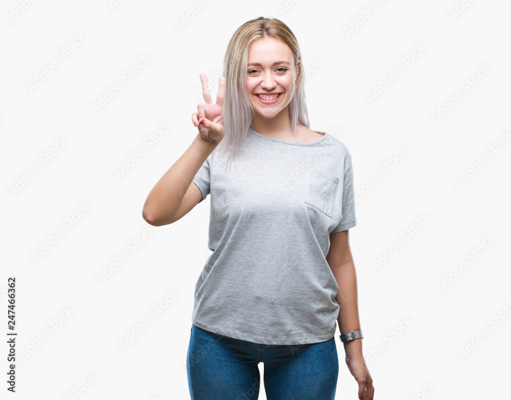 Obraz premium Young blonde woman over isolated background showing and pointing up with fingers number two while smiling confident and happy.