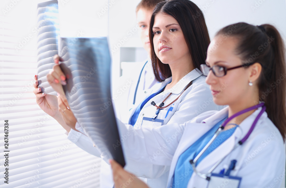 Young group of doctors looking at x-ray Young group of doctors looking at x-ray