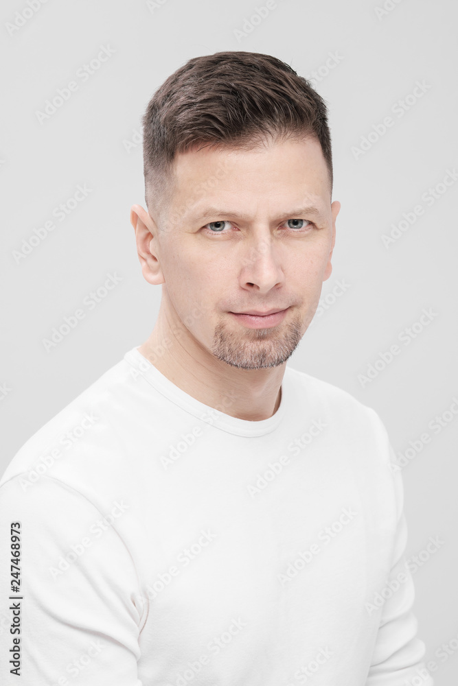 Futuristic handsome bearded brunet man 40s years in white clothes on a white background close-up. God, teacher and boss. Futuristic handsome bearded brunet man 40s years in white clothes on a white background close-up. God, teacher and boss.