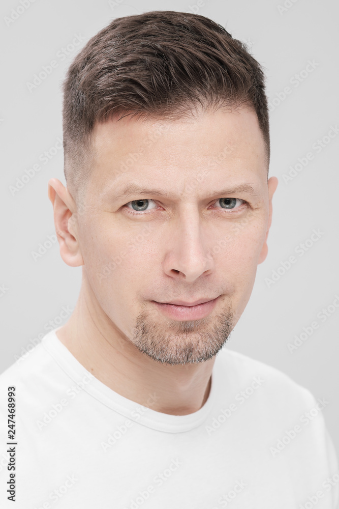 Futuristic handsome bearded brunet man 40s years in white clothes on a white background close-up. God, teacher and boss. Futuristic handsome bearded brunet man 40s years in white clothes on a white background close-up. God, teacher and boss.