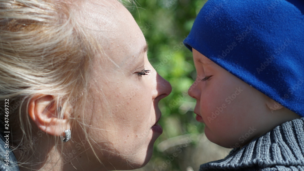 Mother and child with closed eyes in the park Mother and child with closed eyes in the park