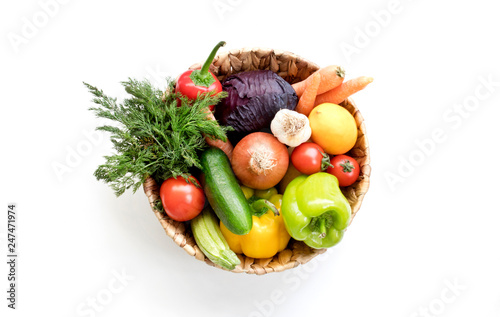  Fresh Vegetables in basket on white isolated background top view.