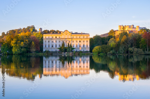 Beautiful sunset colors in Leopoldskroner Weiher Lake with Leopoldskron Palace and Hohensalzburg Fortress in the background - Salzburg, Austria