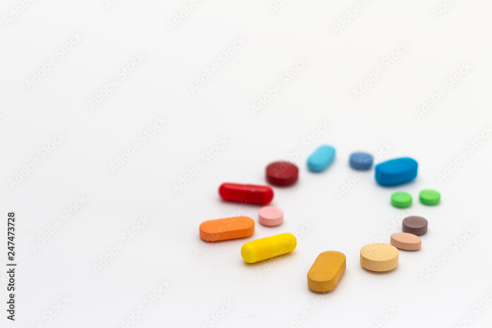 Circle of colored pills on white background. Legal drugs from the pharmaceutical industry. Circle of colored pills on white background. Legal drugs from the pharmaceutical industry.