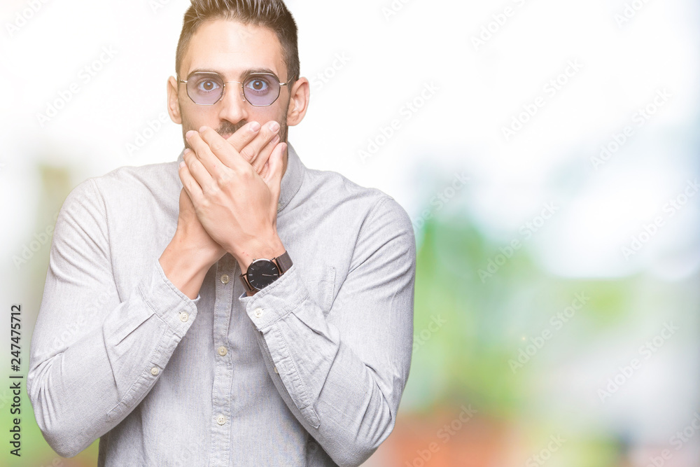 Young handsome man wearing sunglasses over isolated background shocked covering mouth with hands for mistake. Secret concept. Young handsome man wearing sunglasses over isolated background shocked covering mouth with hands for mistake. Secret concept.