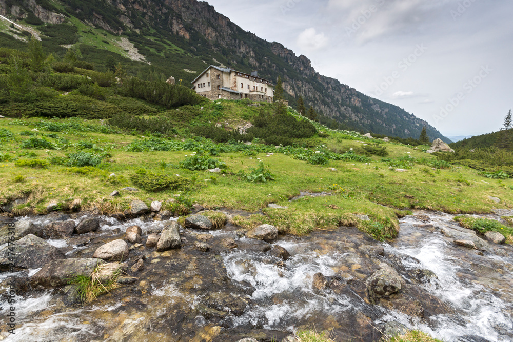 Landscape with dark clouds over Malyovitsa peak and Malyoviska river, Rila Mountain, Bulgaria