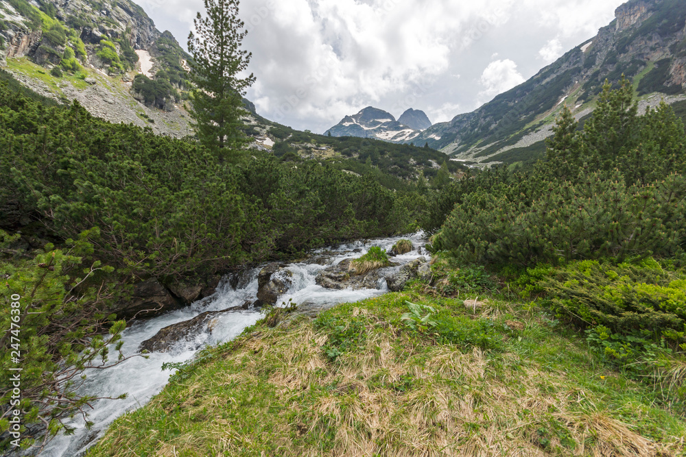 Landscape with dark clouds over Malyovitsa peak and Malyoviska river, Rila Mountain, Bulgaria Landscape with dark clouds over Malyovitsa peak and Malyoviska river, Rila Mountain, Bulgaria