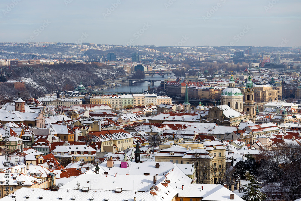Snowy Prague City with St. Nicholas' Cathedral from Hill Petrin in the sunny Day, Czech republic