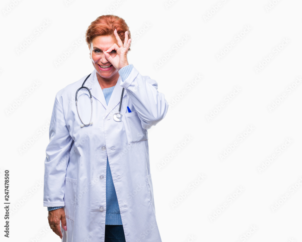 Senior caucasian doctor woman wearing medical uniform over isolated background doing ok gesture with hand smiling, eye looking through fingers with happy face.