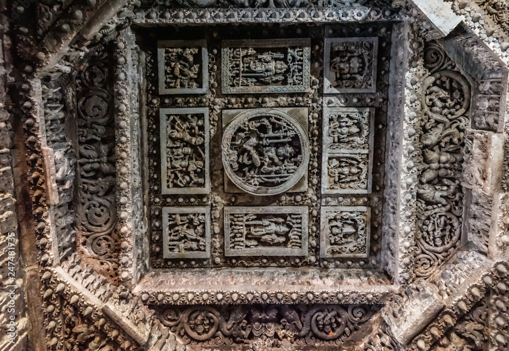 Halebidu, Karnataka, India - November 2, 2013: Hoysaleswara Temple of Shiva. Extensively decorated square mandala in octogenal mandala on ceiling in Mandapam.