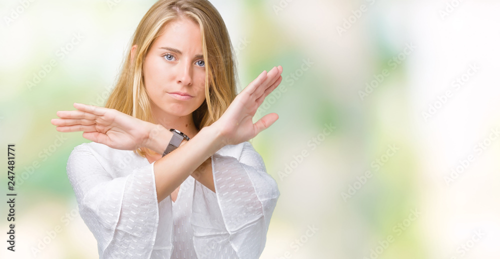 Beautiful young elegant woman over isolated background Rejection expression crossing arms doing negative sign, angry face