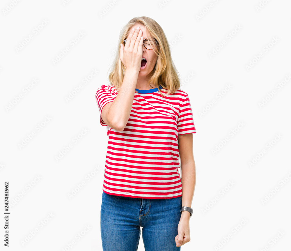 Beautiful young woman wearing glasses over isolated background Yawning tired covering half face, eye and mouth with hand. Face hurts in pain. Beautiful young woman wearing glasses over isolated background Yawning tired covering half face, eye and mouth with hand. Face hurts in pain.