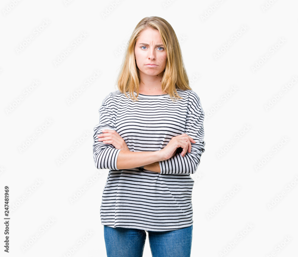 Beautiful young woman wearing stripes sweater over isolated background skeptic and nervous, disapproving expression on face with crossed arms. Negative person. Beautiful young woman wearing stripes sweater over isolated background skeptic and nervous, disapproving expression on face with crossed arms. Negative person.