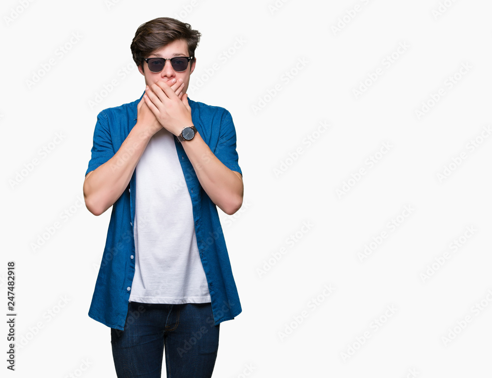 Young handsome man wearing sunglasses over isolated background shocked covering mouth with hands for mistake. Secret concept. Young handsome man wearing sunglasses over isolated background shocked covering mouth with hands for mistake. Secret concept.