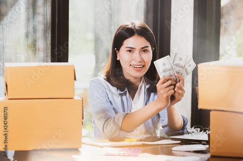 Asia woman holding us dollar banknotes money smiles with happy. photo