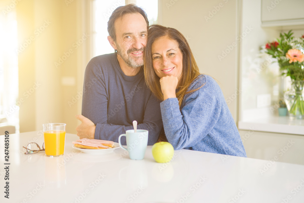 Beautiful romantic middle age couple having healthy breaskfast in the morning at home