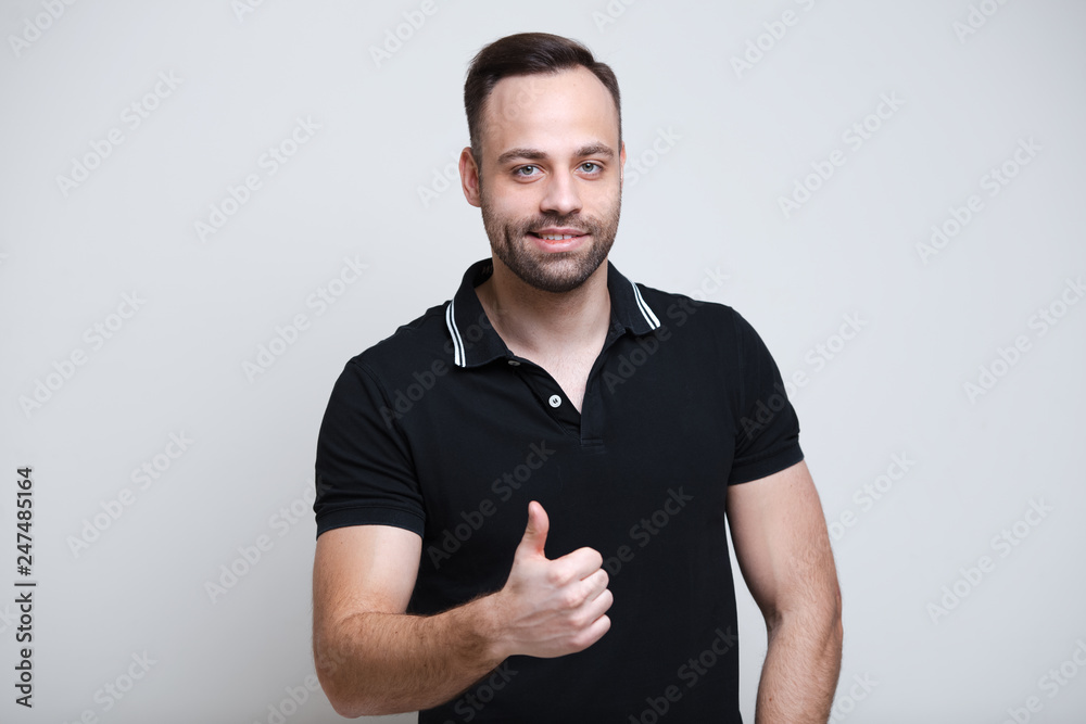Portrait of smiling young man thumb up over white background. Portrait of smiling young man thumb up over white background.